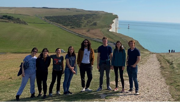 Photo of Jamie Blundell and his research team on a cliff top overlooking the sea